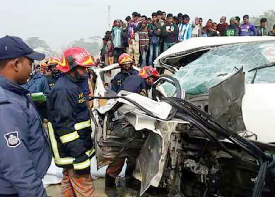 People look on the accident of a microbus which was turned over losing its control at Bhanga Upazila in Faridpur district on Friday killing two co-artistees of Artistee Nakul Kumar Biswas.