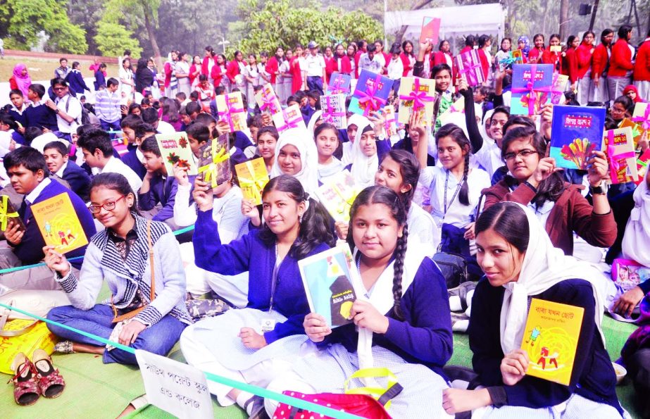 Students rejoicing with books distributed by Bishwa Sahitya Kendra in the city's Suhrawardy Udyan on Friday as part of book reading programme for school students.