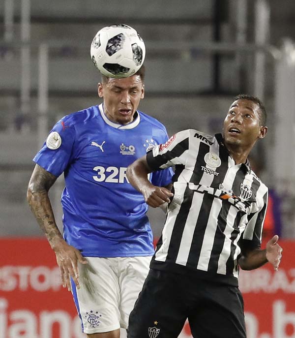 Glasgow Rangers' James Tavernier (left) goes against Atletico Mineiro's Leleu during the first half of a Florida Cup soccer match on Thursday.