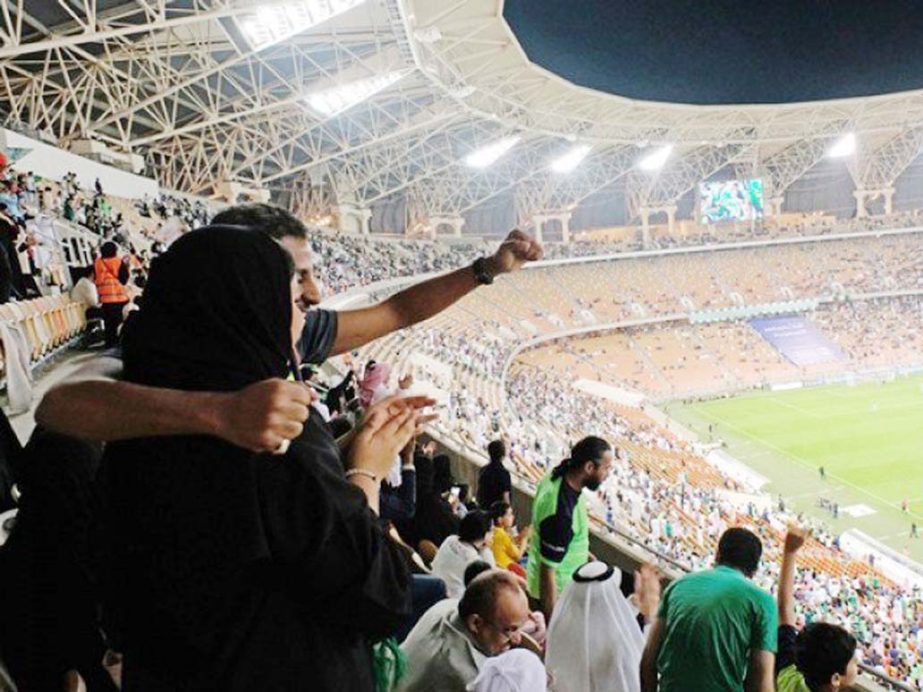 Saudi women watch the soccer match between Al-Ahli against Al-Batin at the King Abdullah Sports City in Jeddah, Saudi Arabia on Friday.