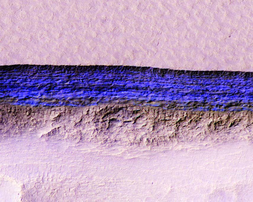 A cross-section of underground ice is exposed at the steep slope that appears bright blue in this enhanced-color view from the HiRISE camera on NASA's Mars Reconnaissance Orbiter. The scene is about 550 yards wide. The scarp drops about 140 yards from th
