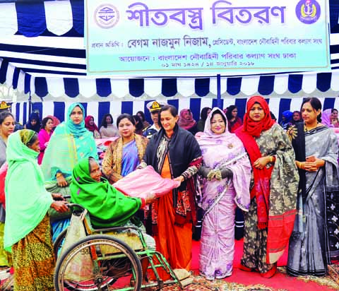 President of Bangladesh Noubahini Paribar Kalyan Sangha Begum Nazmun Nizam distributing winter clothes among the destitute at Nabik Colony ground in the city's Mirpur on Sunday. ISPR photo