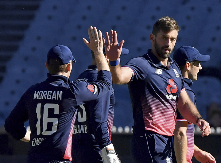 England's Liam Plunkett (right) is congratulated by captain England's Eoin Morgan after capturing the wicket of Australia's Tim Paine during their ODI cricket match in Melbourne, Australia on Sunday.