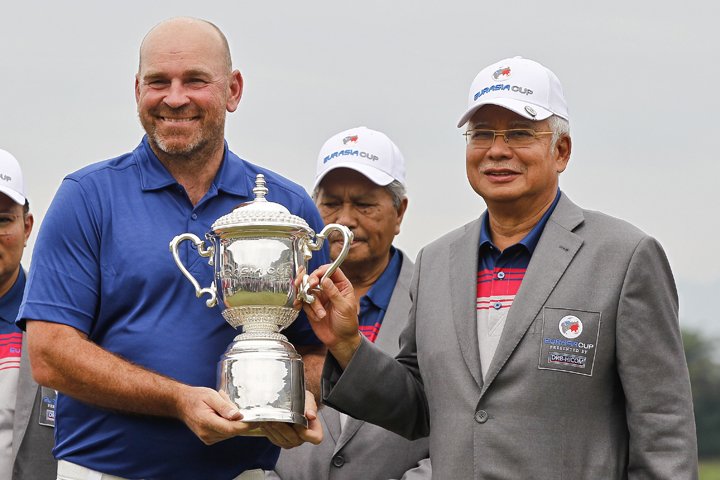 Team Europe captain Thomas BjÃ¸rn of Denmark (left) poses with the trophy handed over from Malaysian Prime Minister Najib Razak (right) after his team won the EurAsia Cup golf tournament at Glenmarie Golf & Country Club in Shah Alam, Malaysia on Sunday.