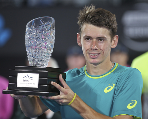 Alex De Minaur of Australia holds his runners' up trophy after losing to Daniil Medvedev of Russia in their men's final singles match at the Sydney International tennis tournament in Sydney on Saturday.