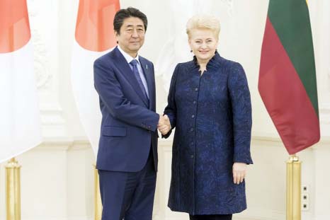 Lithuania's President Dalia Grybauskaite, right shaking hands with Japanese Prime Minister Shinzo Abe at the President's palace in Vilnius, Lithuania on Saturday.