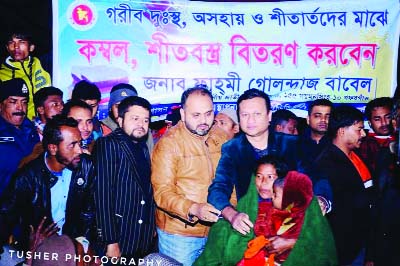 GAFARGAON (Mymensingh): Fahmi Golandaz Babel MP distributing blankets among the poor people at Gafargaon Railway Station recently.