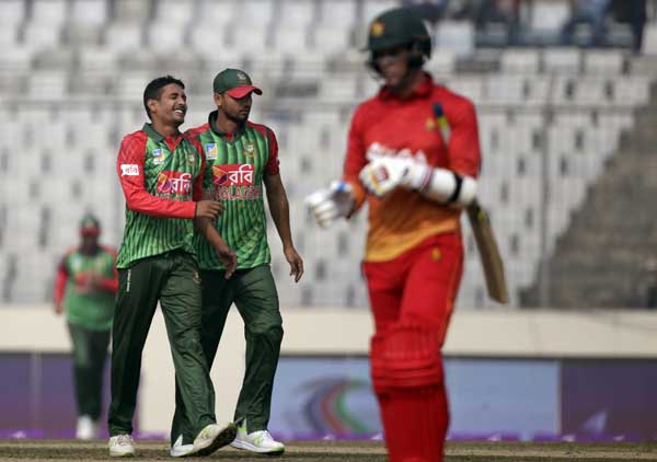Bangladesh's Sunzamul Islam (left) reacts to celebrate with captain Mashrafe Bin Mortaza after the dismissal of Zimbabwe's Malcolm Waller (right) during the first match of their Tri-Nation One-Day International cricket series at Sher-e-Bangla National C