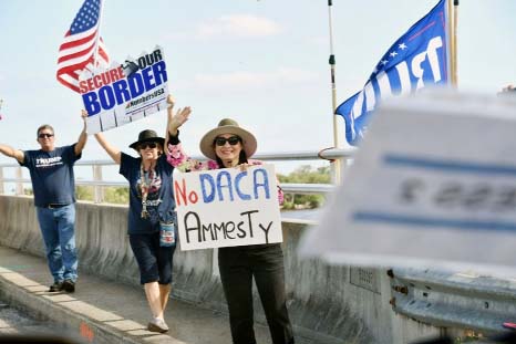 Supporters of US President Donald Trump hold signs near his Mar-a-Lago resort in West Palm Beach in Florida.