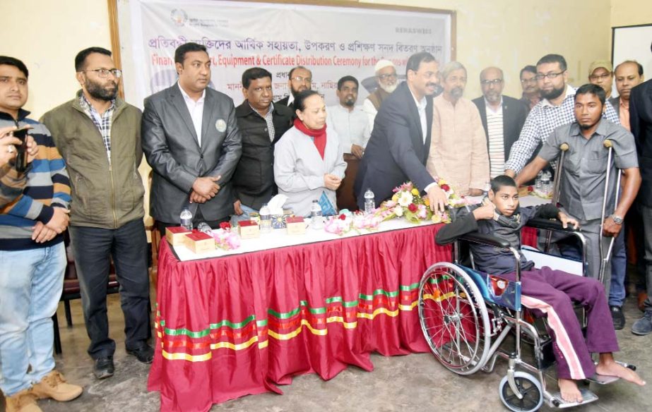 CCC Mayor A J M Nasir Uddin distributing wheel chairs among some disabled children organised by Bright Bangladesh Forum at the Port City on Sunday.