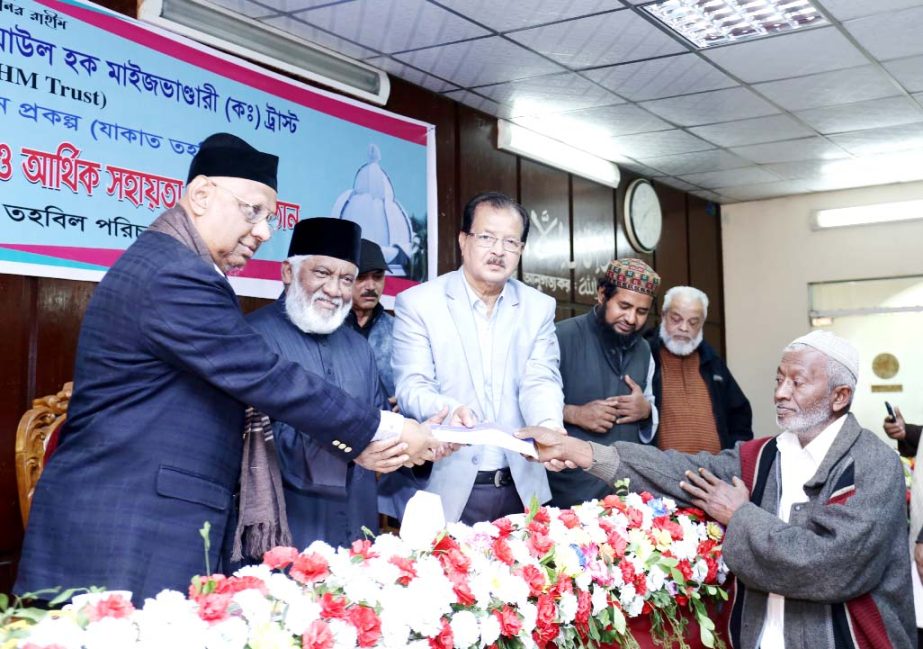 Chairman of PHP family Alhaj Sufi Mizanur Rahman distributing cheque among the destitute people on behalf of Syed Ziaul Hoque Maizbhandari Trust on Saturday.