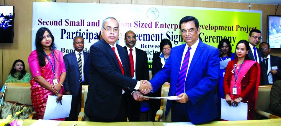 Md. Abdul Halim Chowdhury, Managing Director of Pubali Bank Limited and Md. Abul Bashar, General Manager of Financial Inclusion Department of Bangladesh Bank (BB), exchanging an agreement signing documents on "Refinance Scheme for setting up Small Medium