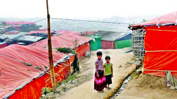 Rohingya refugee children walk in Palong Khali camp, near Cox's Bazar, Bangladesh on Sunday.