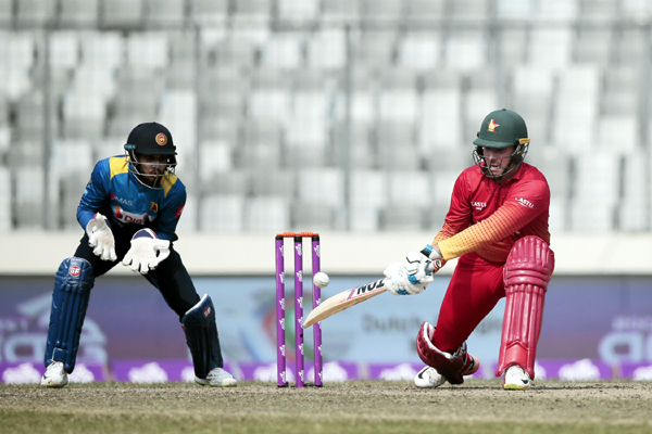 Zimbabwe's Brendan Taylor (right) plays a shot as Sri Lanka's wicketkeeper Dinesh Chandimal watches during the Tri-Nation One-Day International cricket series at the Sher-e-Bangla National Cricket Stadium in Mirpur on Wednesday.