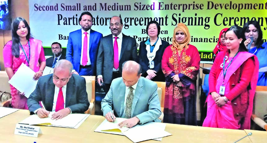 AKM Kamruzzaman, Managing Director (CC) of LankaBangla Finance Limited and Md. Abul Bashar, General Manager of Financial Inclusion Department of Bangladesh Bank, exchanging an agreement signing documents on "Refinance Scheme for setting up Small Medium E
