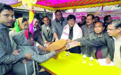 DINAJPUR(South): Azizul Imam Chowdhury, Chairman, Dinajpur Zilla Parishad distributing winter clothes among the cold- hit people at Fulbari Upazila on Wednesday.