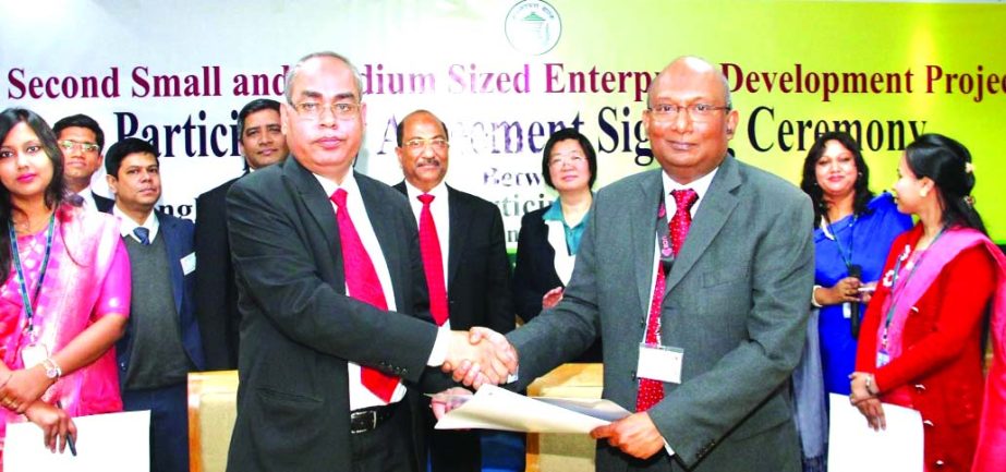 AE Abdul Muhaimen, Managing Director of UCB and Md. Abul Bashar, General Manager of Financial Inclusion Department of Bangladesh Bank (BB), exchanging an agreement signing documents on "Refinance Scheme for setting up Small Medium Enterprise Development