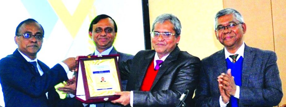 Md. Touhidul Alam Khan, DMD and Chief Business Officer of Prime Bank Limited, receiving the crest as Panel Specialist from Jamal Ahmed Choudhury, President of Institute of Cost and Management Accountants of Bangladesh (ICMAB) in a Conference on "Changing