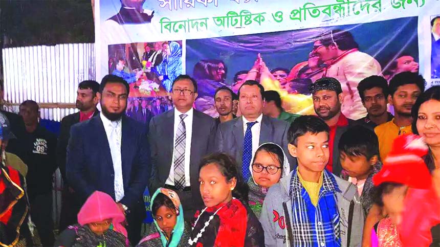 Commerce Secretary Subhasish Basu, passes time with the autistic children at Sarika Fantasy Park of 23rd Dhaka International Trade Fair in the city on Wednesday. Mahbubur Rahman Palash, Managing Director of the park, Bijoy Bhattacharjee, Vice Chairman, Ab