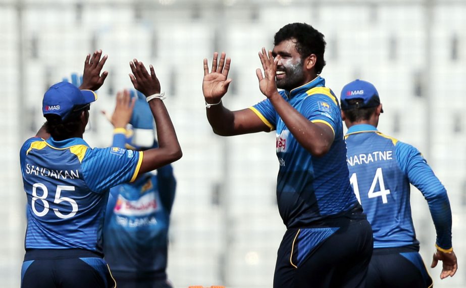 Sri Lanka's Thisara Perera (second right) celebrates with his teammates after the dismissal of Zimbabwe's Sikandar Raza during the Tri-Nation One-Day International cricket series at the Sher-e-Bangla National Cricket Stadium in Mirpur on Sunday.
