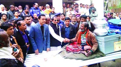 LALMONIRHAT: State Minister for Social Welfare Nuruzzaman Ahmed distributing relief goods among the flood -hit people at a function at Aditmari Upazila Parishad Hall Room as Chief Guest on Sunday.