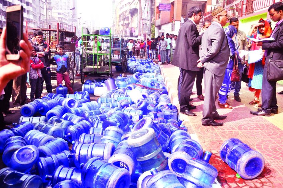 BSTI mobile court detained six persons from different city areas involved in selling of contaminated waters and penalized them. Photo shows huge water containers being dumped at Palton area on Monday.