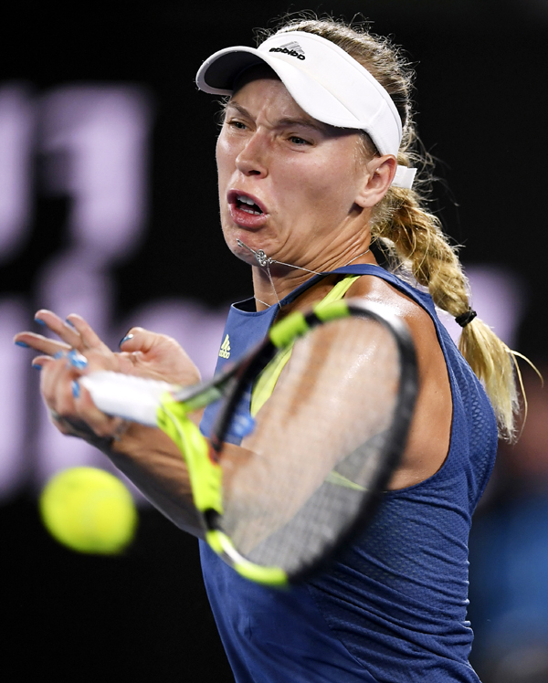 Denmark's Caroline Wozniacki hits a forehand return to Spain's Carla Suarez Navarro during their quarterfinal at the Australian Open tennis championships in Melbourne, Australia on Tuesday.