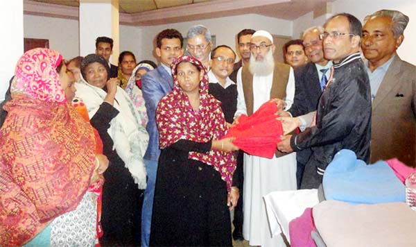 Leaders of the Bishwajanin Shanti Sangha led by Principal Dr Abdul Karim distributing winter clothes among poor members of the society in the city yesterday.