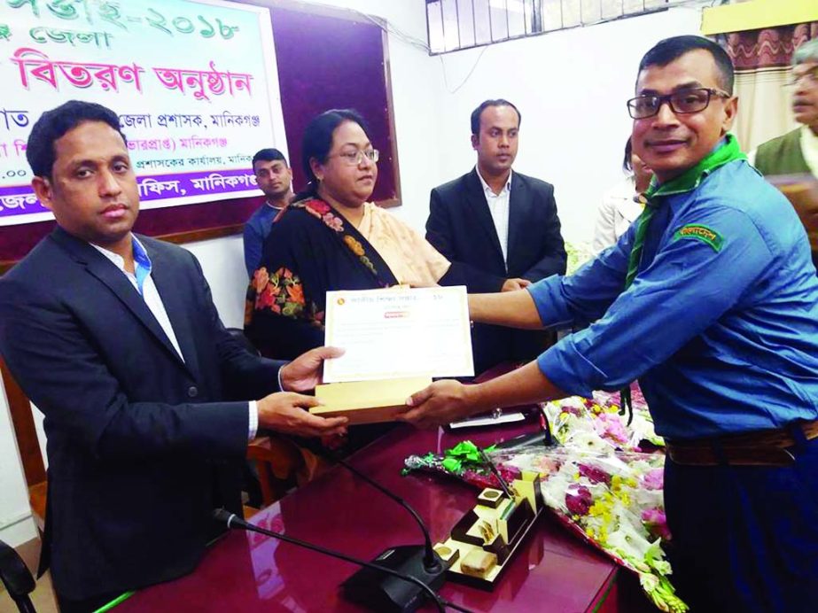 MANIKGANJ: Nazmus Sadat Salim, Additional DC, Manikganj giving honorary crest to Md Altaf Hossain, teacher of Singair Model Pilot High School as he has been elected as the best scout teacher of the district at DC office organised by National Educatio