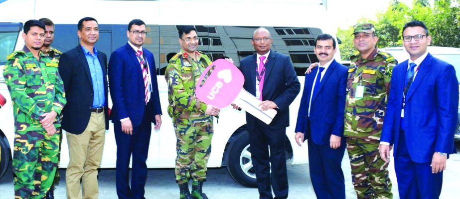AE Abdul Muhaimen, Managing Director of United Commercial Bank Limited, handing over the key of a vehicle to Colonel Md Shahidul Alam, Executive Director and Principal of 'Proyash' (An Army operated Institute of Special Needs) at its office in the city