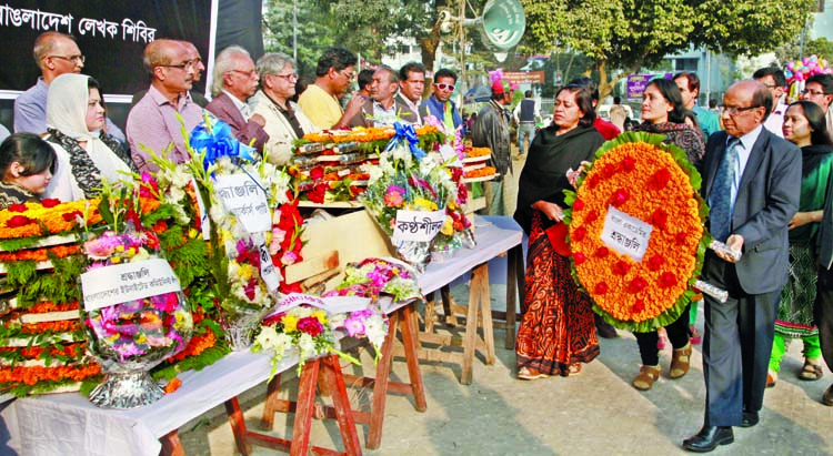 People from all walks of life paid tributes to Litterateur Shawkat Ali by placing floral wreaths on his coffin at the Central Shaheed Minar in the city on Thursday.