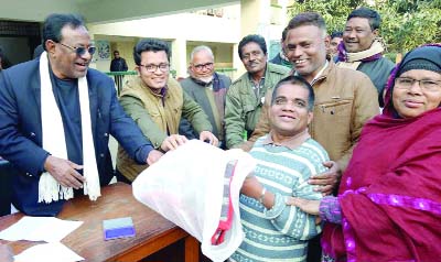 THAKURGAON: Pirganj Upazila Administration distributing warm clothes among the cold- hit people at Municipal area on Monday.