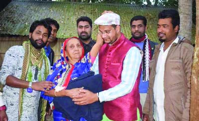 MADARIPUR: Jasim Uddin Mridha , Joint General Secretary, Shibchar Thana Jubo Dal distributing blankets among the cold -hit people at Sanyasir Char on behalf of Kamal Zaman Nuruddin Mollah, Convener, BNP , Shibchar Thana yesterday.