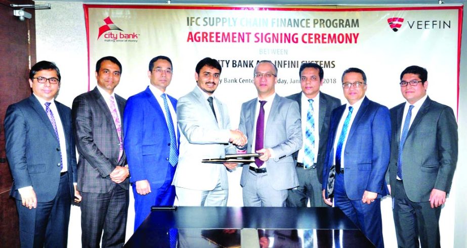 Mashrur Arefin, AMD of City Bank Limited and Jigar Shah, Chief Operating Officer of Infini Systems (a solution for Supply Chain Finance) exchanging an agreement signing documents at the banks head office in the city recently. Adil Islam, AMD, Kazi Azizur