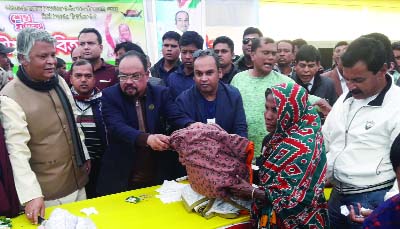 MANIKGANJ: AM Naimur Rahman Durjoy MP distributing winter clothes among the cold-hit people as Chief Guest on behalf of Bashundhara Group at Daulatpur PS Model High School recently.