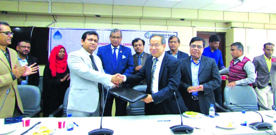 Engineer Ka Sa Ching, DWASA Superintendent and Khairul Matin, KMC Managing Director, sign a deal for upgrading the capacity of Pagla Sewage Treatment Plant, financed by World Bank in the city on Thursday. Dhaka WASA Managing Director Engr. Taqsem A Khan