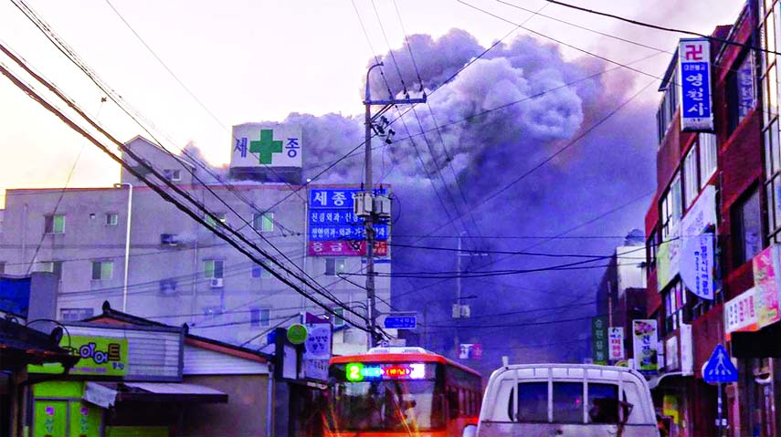 Heavy grey smoke rises into the air from a fire at a hospital building in Miryang on January 26, 2018. At least 41 people were killed in a blaze at a hospital in South Korea, Yonhap news agency said, with dozens more injured.