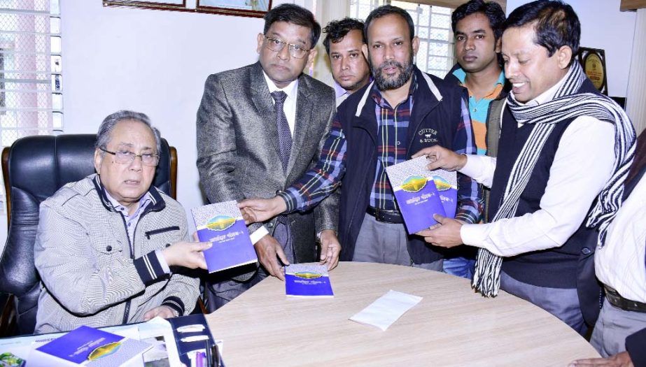 Minister for Forest and Environment Barrister Anisul Islam Mahmud receiving a copy of the book titled 'Sufism Series-2' written by Lions Barun Kumar Acharji Balai recently.