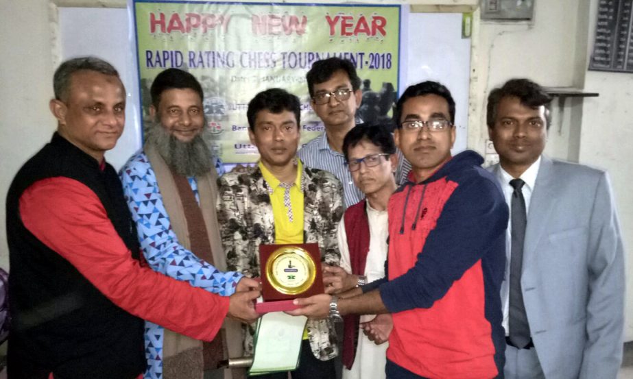 Candidate Master Mahtabuddin Robin, the champion of the Happy New Year International Rapid Rating Chess Tournament with the guests and officials of Uttra Central Chess Club pose for photo at Uttara Ideal College on Friday.