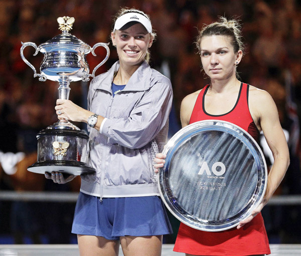 Denmark's Caroline Wozniacki (left) holds her trophy after defeating Romania's Simona Halep (right) in the women's singles final at the Australian Open tennis championships in Melbourne, Australia on Saturday.