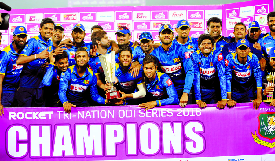 Members of Sri Lanka, the champions of the Tri-Nation ODI series pose with the championship trophy at the flood-lit Sher-e-Bangla National Cricket Stadium in the city's Mirpur on Saturday.