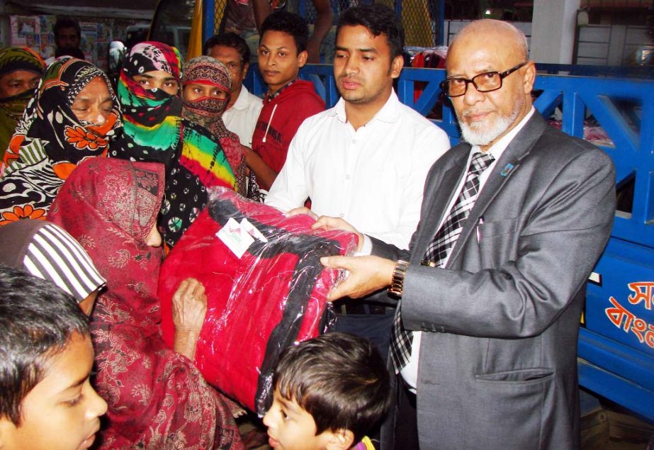 Former Vice Chancellor of Chittagong University and Chairman of Social Islami Bank Ltd Prof Anwarul Azim Arif distributing blankets among the cold affected people at Voaliapara under Satkania Pourashava on Thursday.