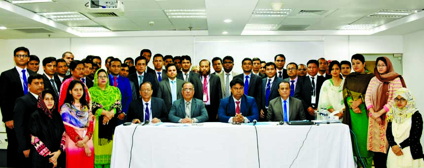 Mosleh Uddin Ahmed, Managing Director of NCC Bank Limited, poses with the participants of a day-long workshop on "Prevention of Money Laundering and Terror Financing" at the banks Training Institute in the city recently. AZM Saleh, DMD and J H Shahedi,