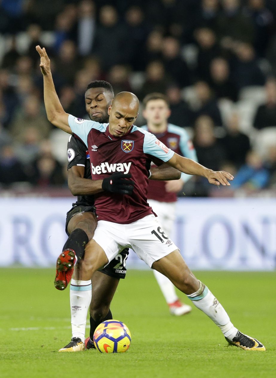 West Ham United's Joao Mario (front) is fouled by Crystal Palace's Timothy Fosu-Mensah during their English Premier League soccer match between West Ham United and Crystal Palace at the London stadium in London on Tuesday.