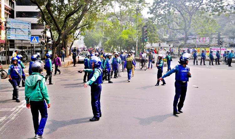 Law enforcers on guard at the Mazar Road areas in front of High Court to foil possible untoward incidents following Begum Khaleda Zia's appearance before the makeshift court at Bakshibazar on Wednesday