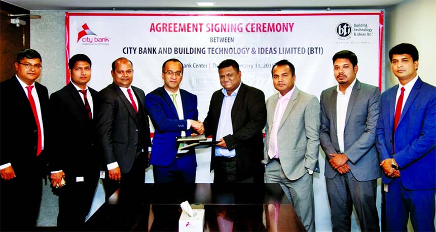 Mashrur Arefin, AMD of City Bank Limited and HM Tarikul Kamrul, Chief Operating Officer of Building Technology and Ideas Limited (BTI), exchanging an agreement signing documents at the bank's head office in the city recently. Under the deal, BTI home buy