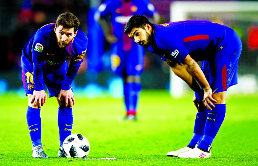 FC Barcelona's Lionel Messi (left) and Luis Suarez during the Spanish Copa del Rey, semifinal, first leg soccer match between FC Barcelona and Valencia at the Camp Nou stadium in Barcelona, Spain on Thursday.