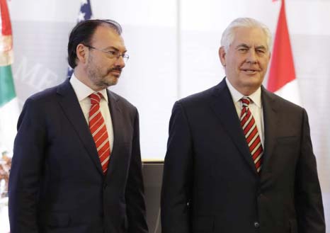 Mexican Foreign Minister Luis Videgaray, and U.S. Secretary of State Rex Tillerson, pose for photos at the end of a joint press conference in Mexico City on Friday.