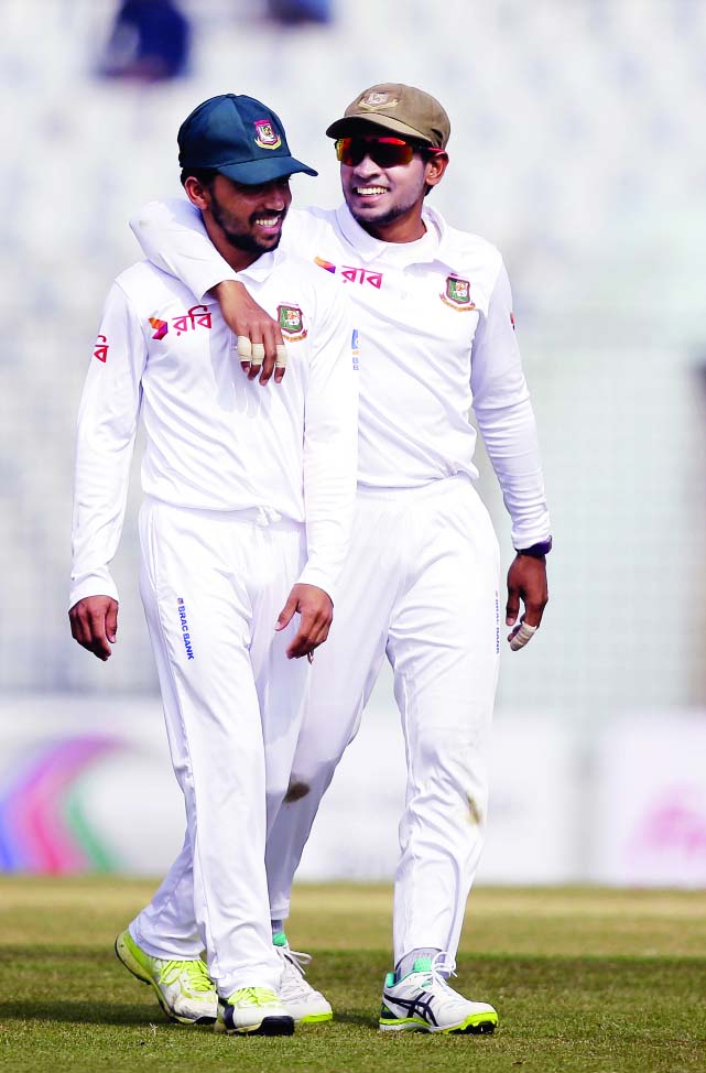 Mushfiqur Rahim (right) and teammate Mominul Haque smile as they field against Sri Lanka during the fourth day of their first Test cricket match in Chittagong on Saturday.