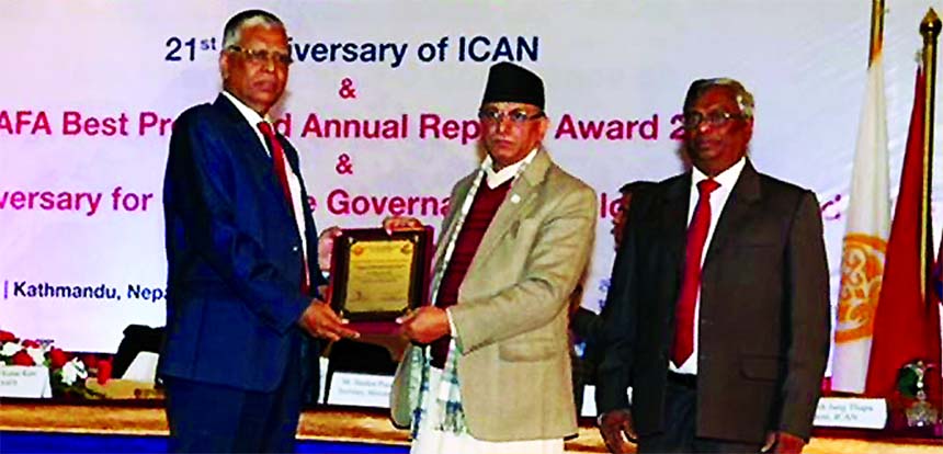 Muhammad Shahjahan, AMD of Southeast Bank Limited, receiving the SAARC Anniversary Award for Corporate Governance for Best Presented Annual Report 2016 award from Tanka Moni Dangal, Auditor General of Nepal at a hotel in Kathmandu on Wednesday.